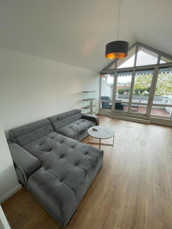 a living room with a couch and a table at Air Apartments 9 in Bremen