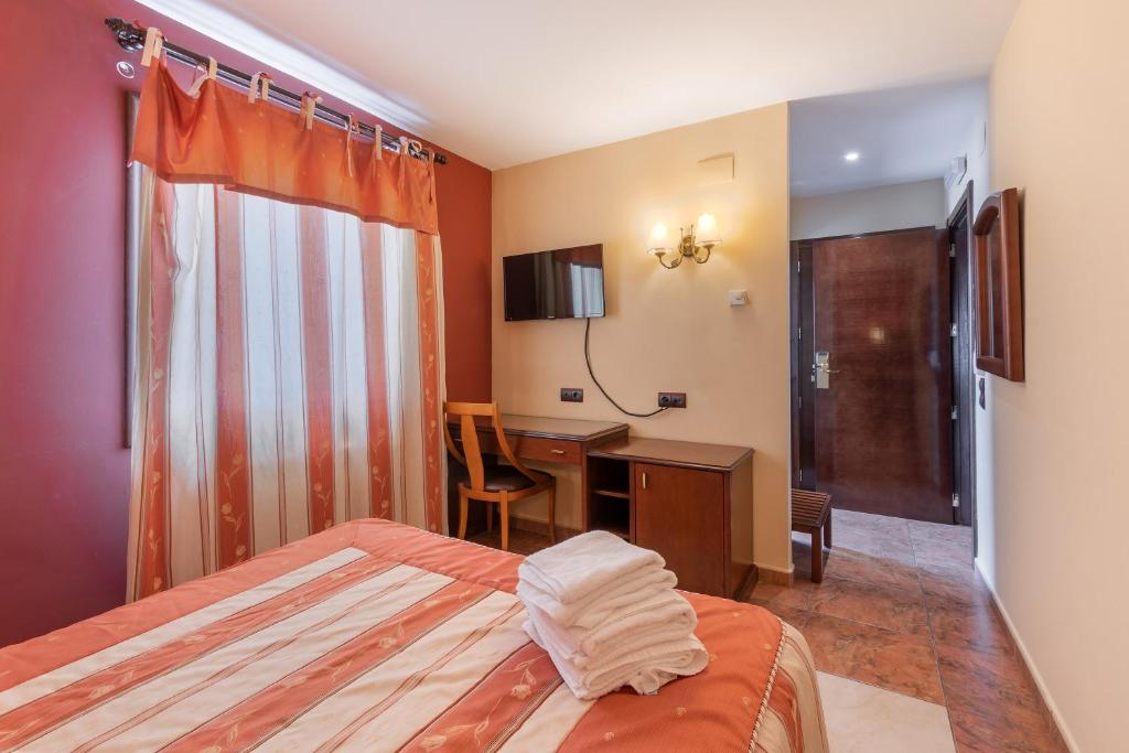 A bed or beds in a room at Hotel Puerta de Javalambre