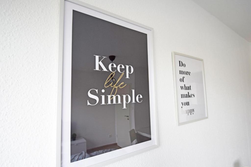 a mirror with the words keep like simple on a wall at Air Apartments 10 in Bremen