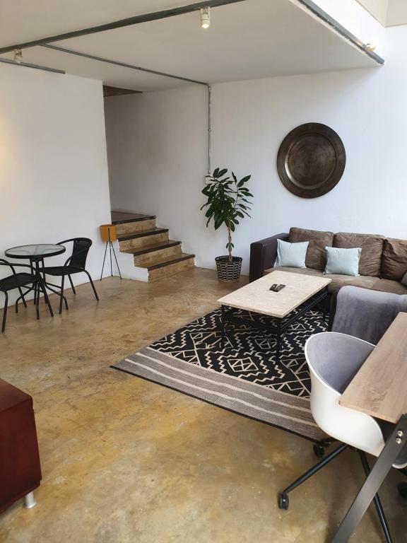 een woonkamer met een bank en een tafel bij LM Loft Maboneng in Johannesburg