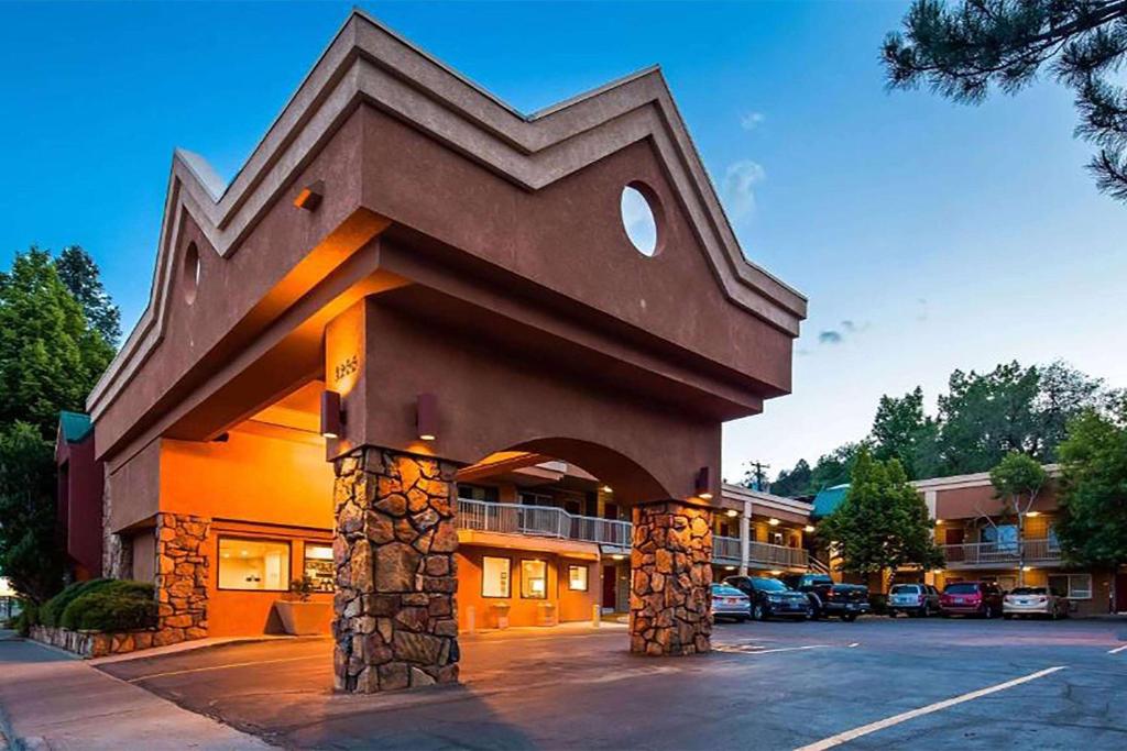 a hotel with a large building with a parking lot at Baymont by Wyndham Durango in Durango