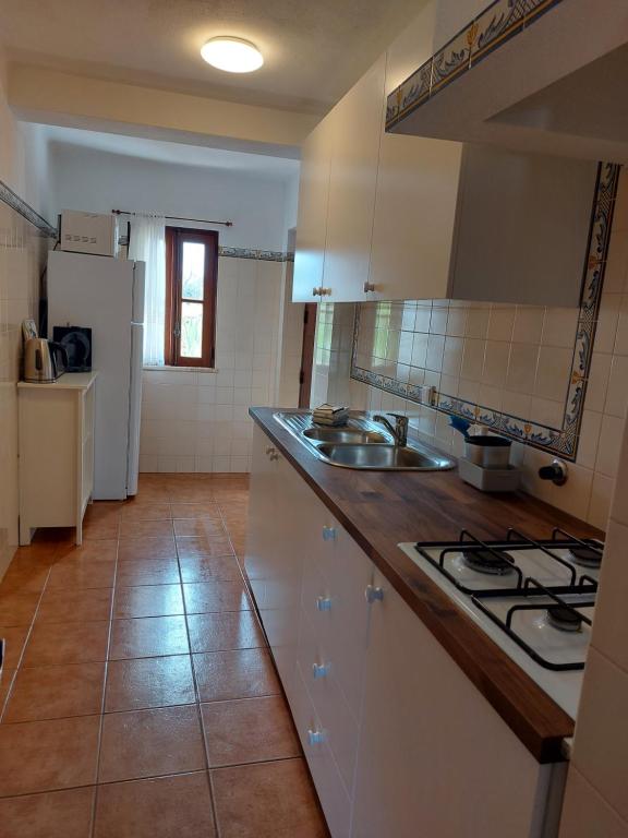a kitchen with a sink and a stove top oven at Hakuna matata in Benagil