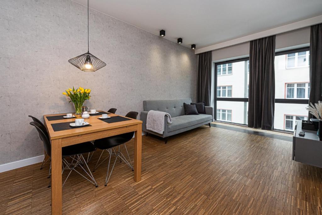 a living room with a table and a couch at Baltiq Plaza - BillBerry Apartments in Gdynia