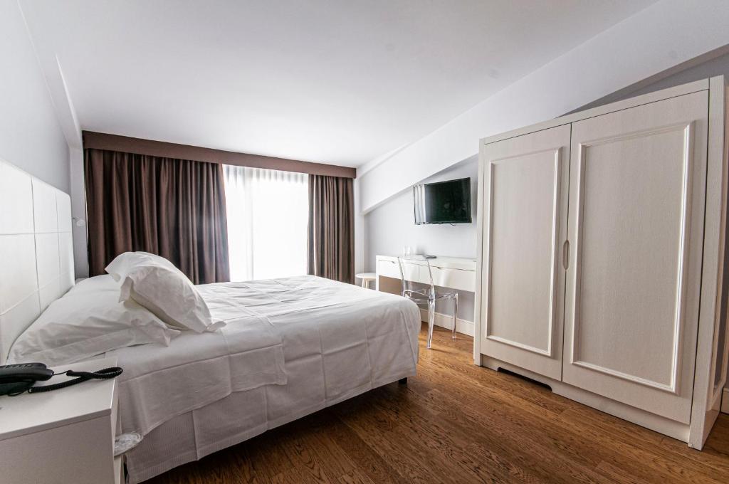 a hotel room with a bed and a desk and a bedroom at Spazio San Marco in Bergamo