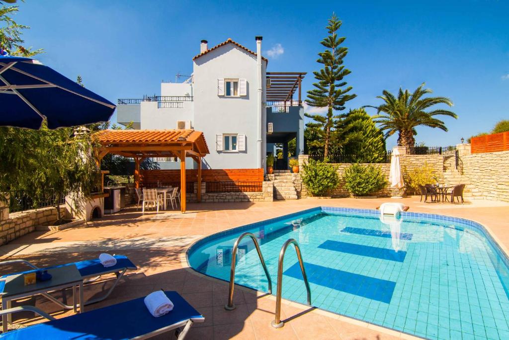 a swimming pool in front of a house at Blue Villa 1 - With Private Pool in Perama