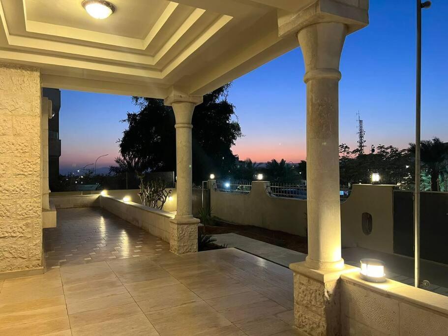 a porch with a view of the city at night at Aqaba Escape 1 in Aqaba