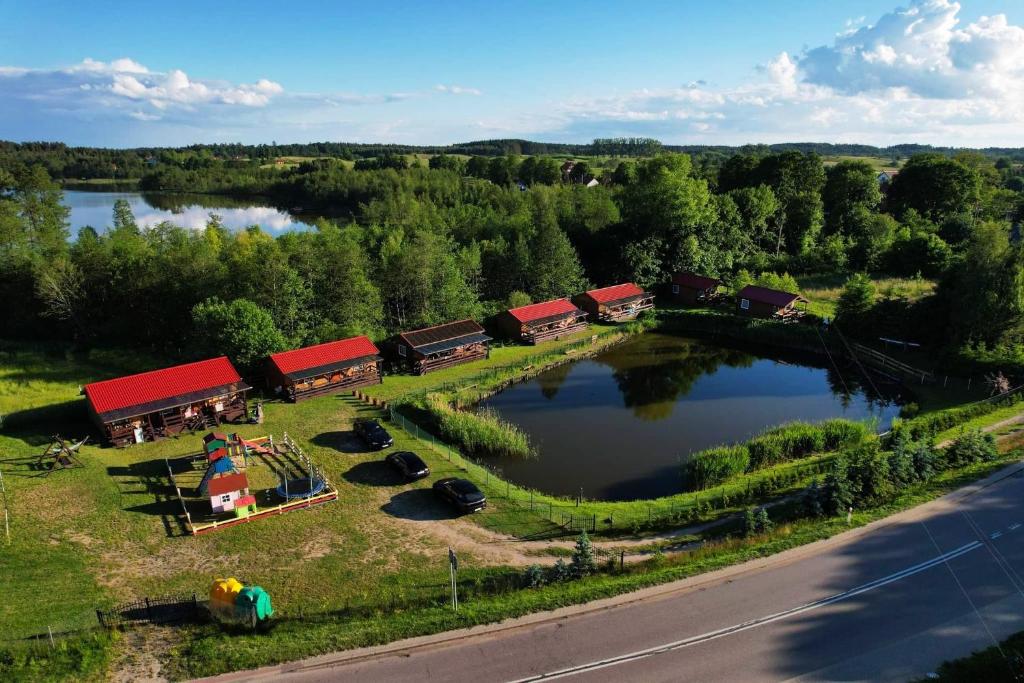 an aerial view of a lake with houses and boats at Domki u Czopera in Zełwągi