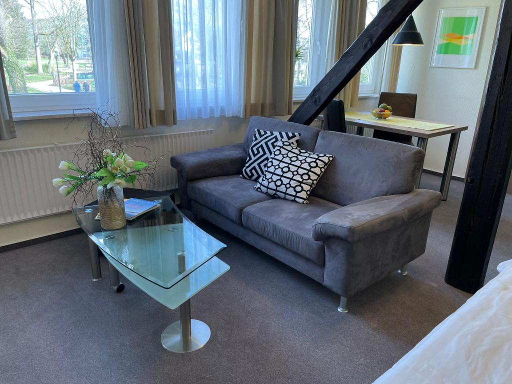 a living room with a couch and a glass table at Ferienwohnung Brunnenhaus in Bad Sassendorf