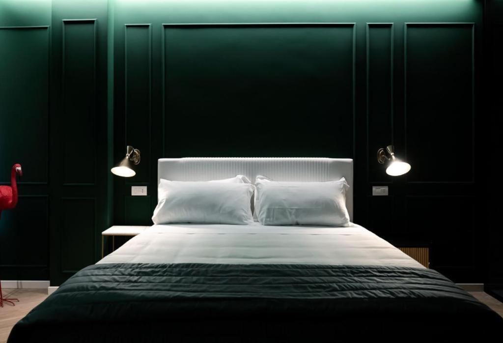 a bedroom with a large bed with two white pillows at Salotto Room Boutique Pescara in Pescara
