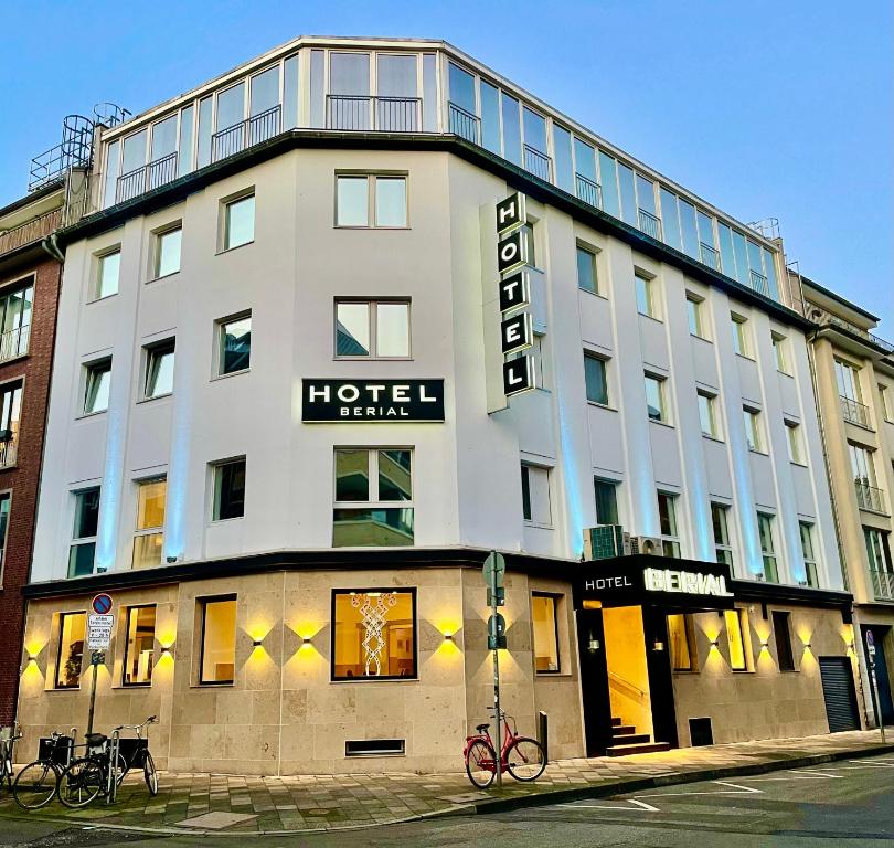 a hotel building with a sign on top of it at Boutique Hotel Düsseldorf Berial in Düsseldorf