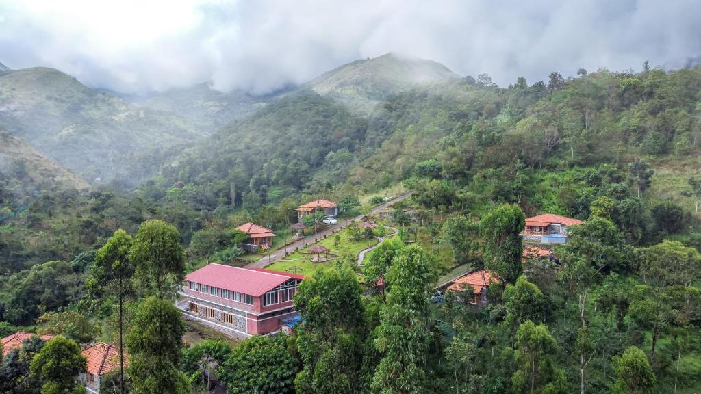 a building in the middle of a mountain at ZACS VALLEY RESORT, Kodaikanal in Kodaikānāl
