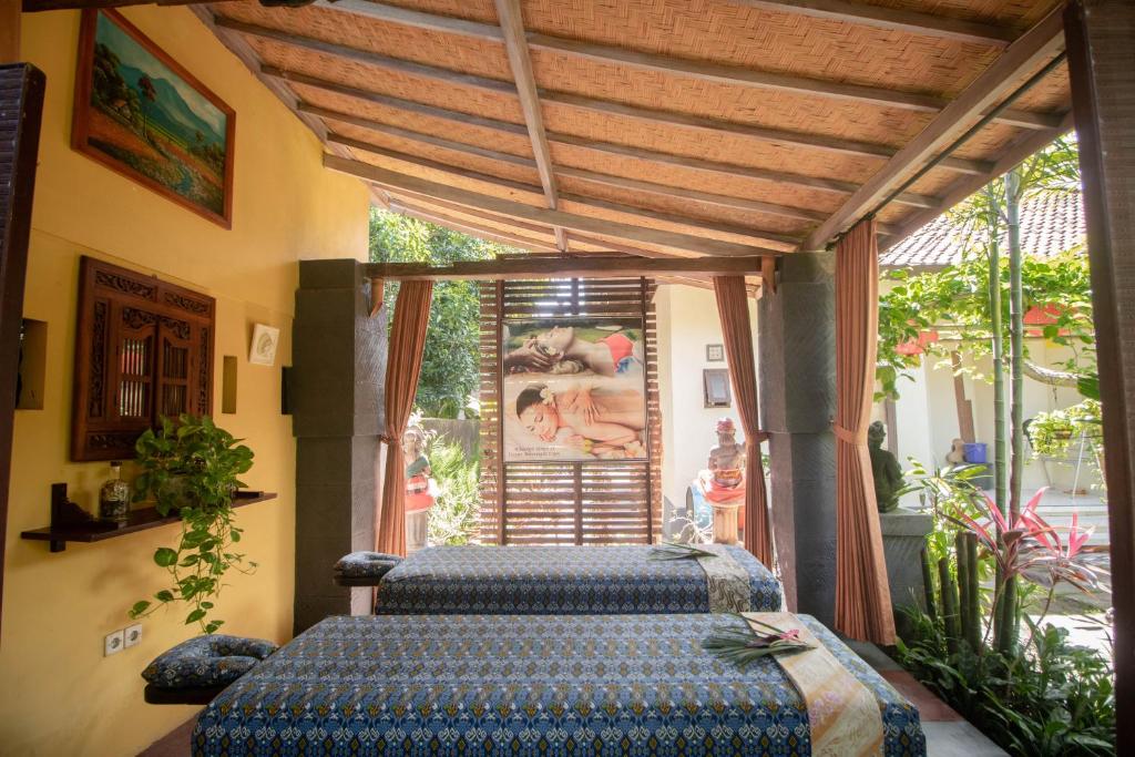 Postel nebo postele na pokoji v ubytování Giri Sari Guest House Pemuteran Bali
