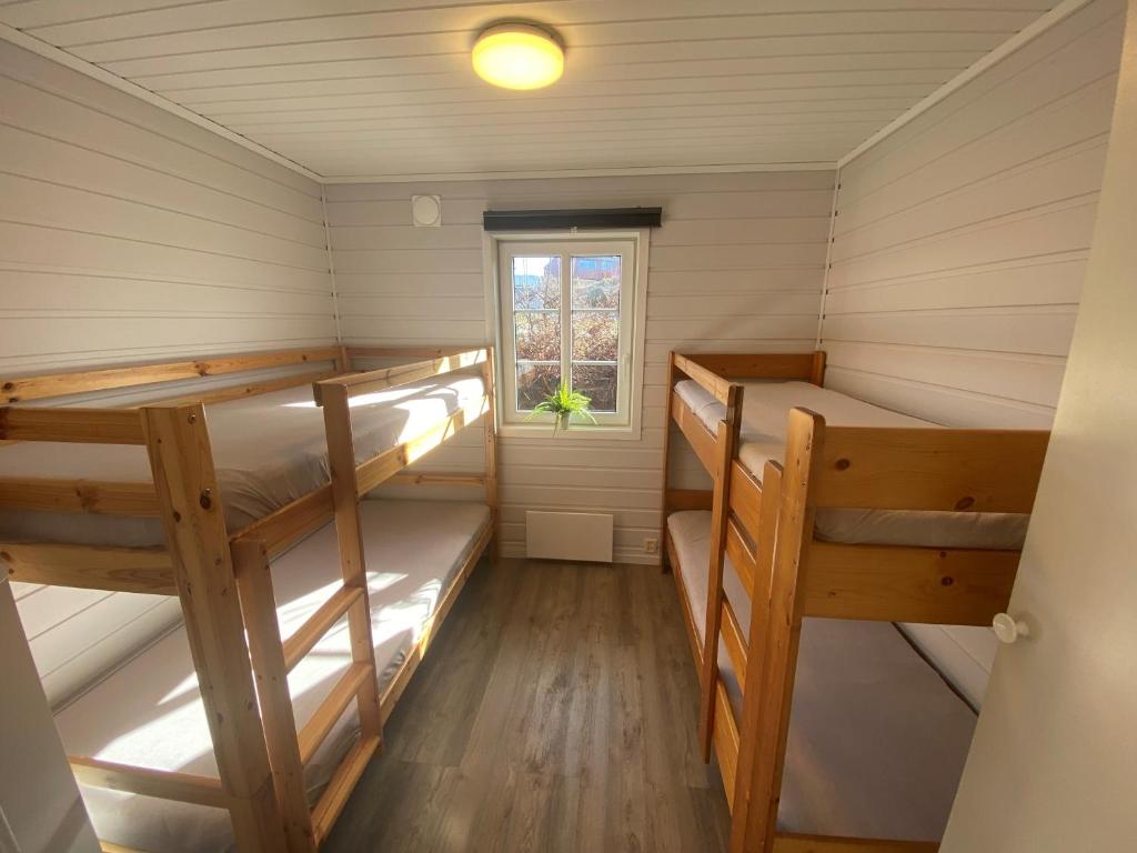 a cabin with two bunk beds in it at Haraldshaugen Camping in Haugesund