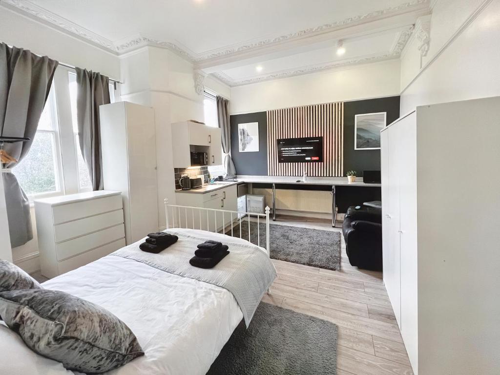 a bedroom with a white bed and a desk at Erin Court Mansions - Suite 13 in Croydon