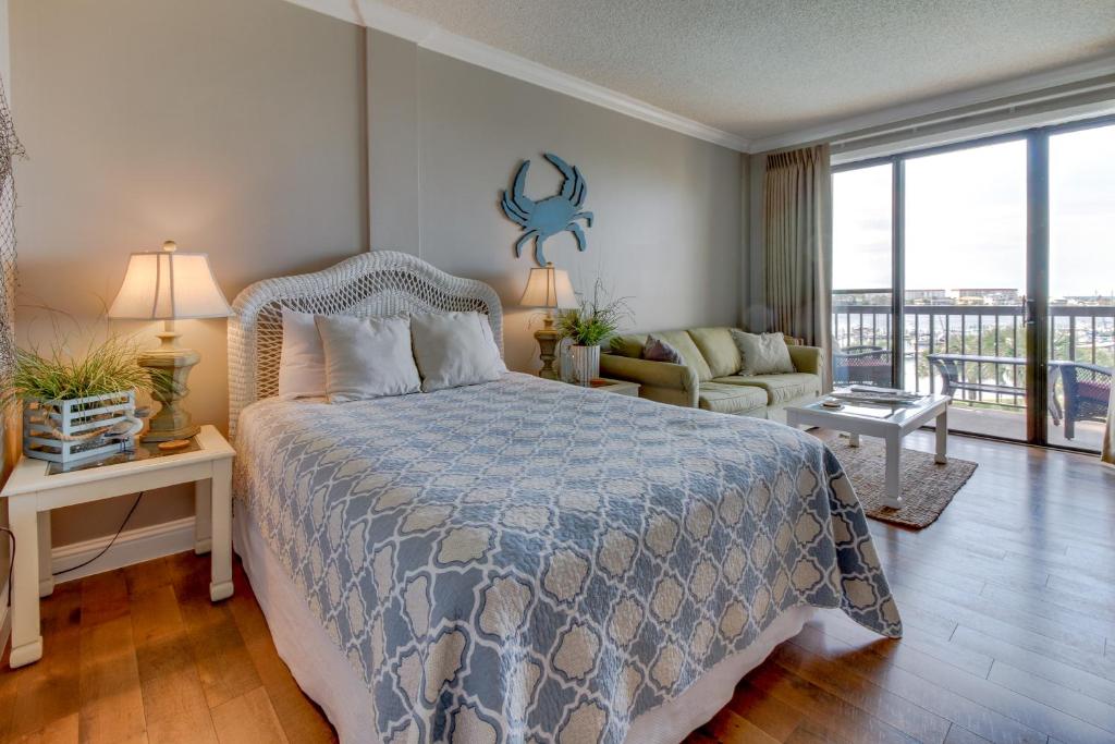a bedroom with a bed and a living room at Pirates Bay A409 in Fort Walton Beach