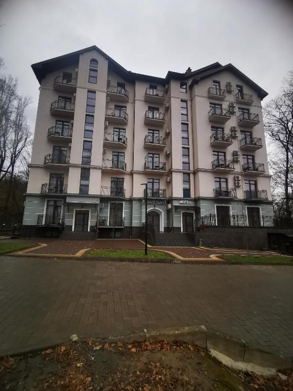 a large white building with a lot of windows at КарпатиКайзервальд. in Karpaty