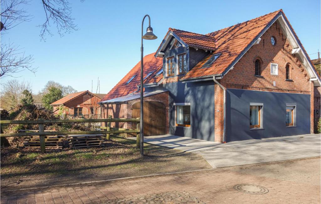 a blue house with a red roof at Gorgeous Apartment In Loxstedt With Kitchen in Loxstedt