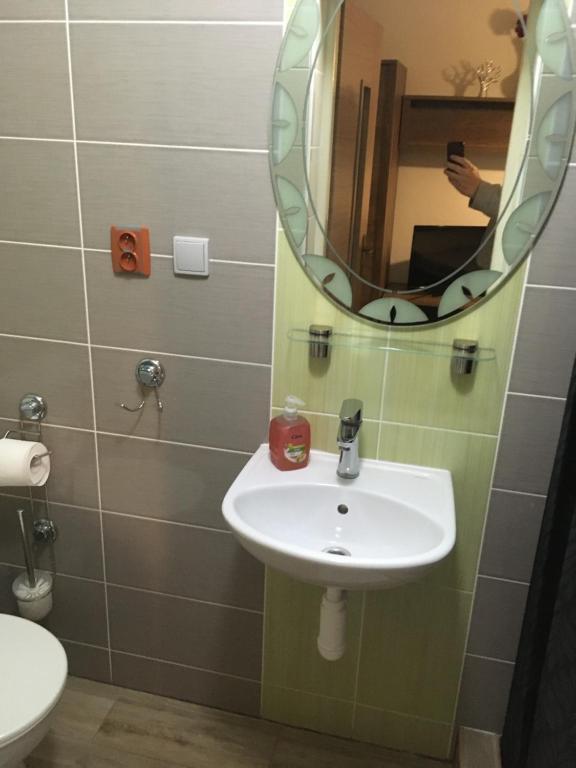 a bathroom with a sink and a mirror at HARRYS City Motel in Komárno