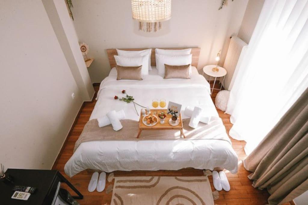 a bedroom with two beds with a table on it at Cozy Apartment in the heart of Athens! in Athens