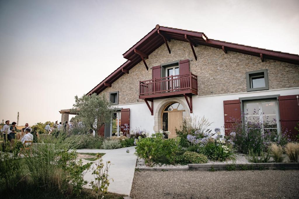 a building with a balcony on top of it at Domaine Etxezahar in Bardos