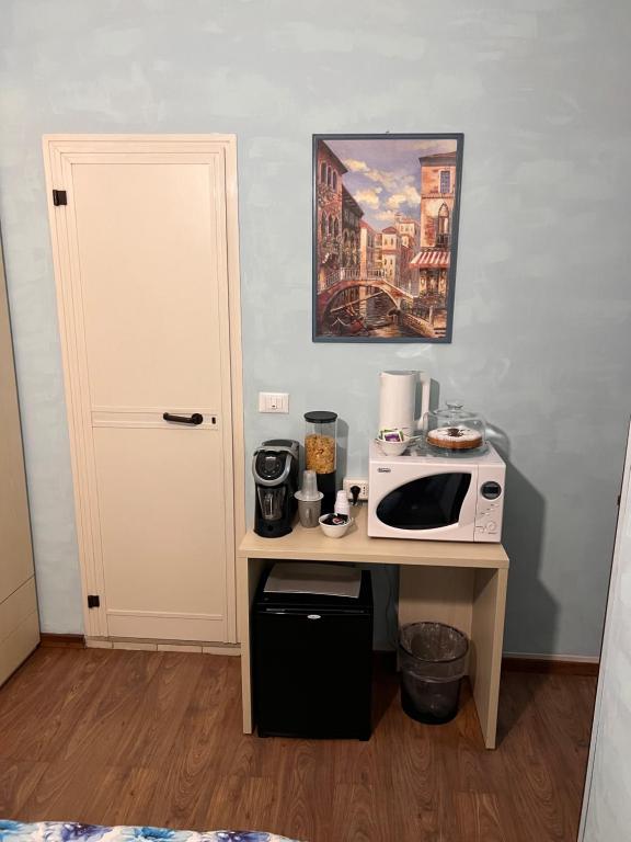 a kitchen with a table with a microwave on it at B&B I' Chivi in Incisa in Valdarno