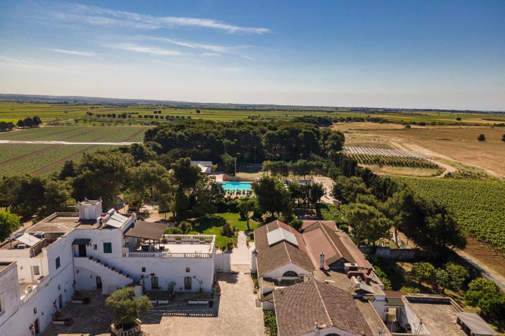 an aerial view of a white house with a yard at Tenuta del Barco in Pulsano