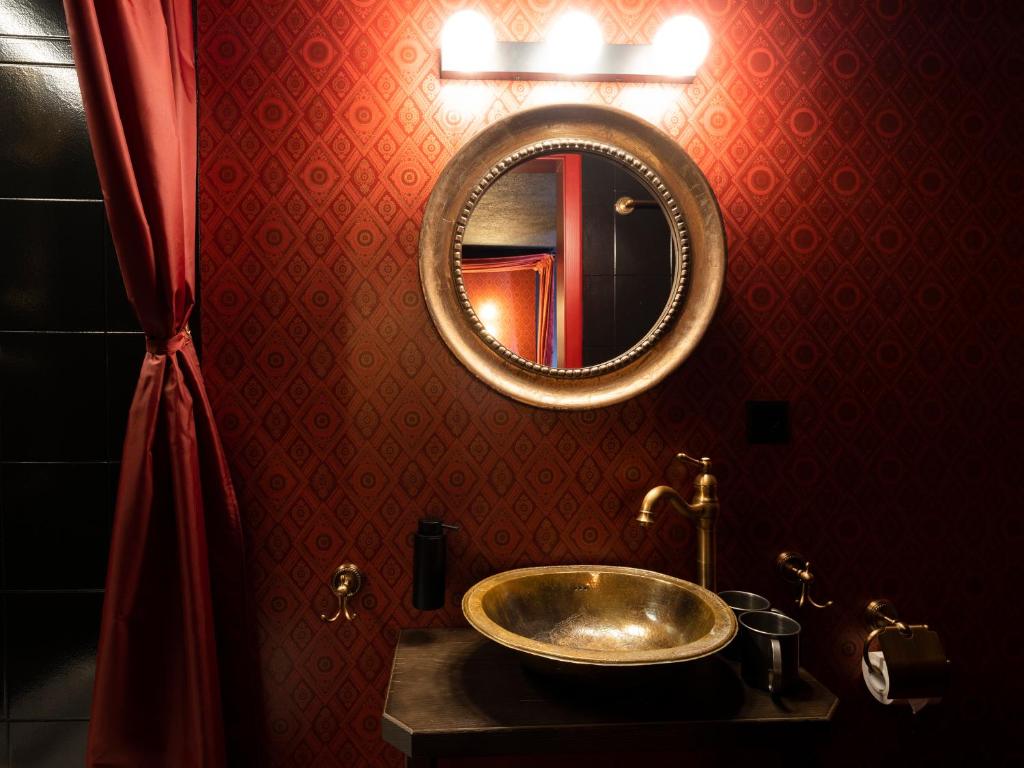 a bathroom with a sink and a mirror at Peanut Medieval Lodge in Saint-Ursanne