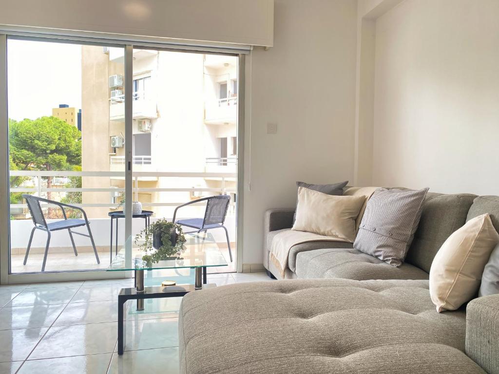 sala de estar con sofá y mesa de cristal en Phaedrus Living Down Town Flat Nestoras 301, en Limassol