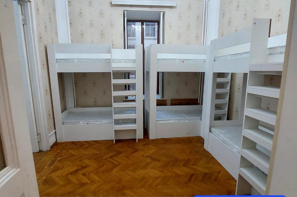 a room with three bunk beds in a room at A & F HOSTEL in Baku