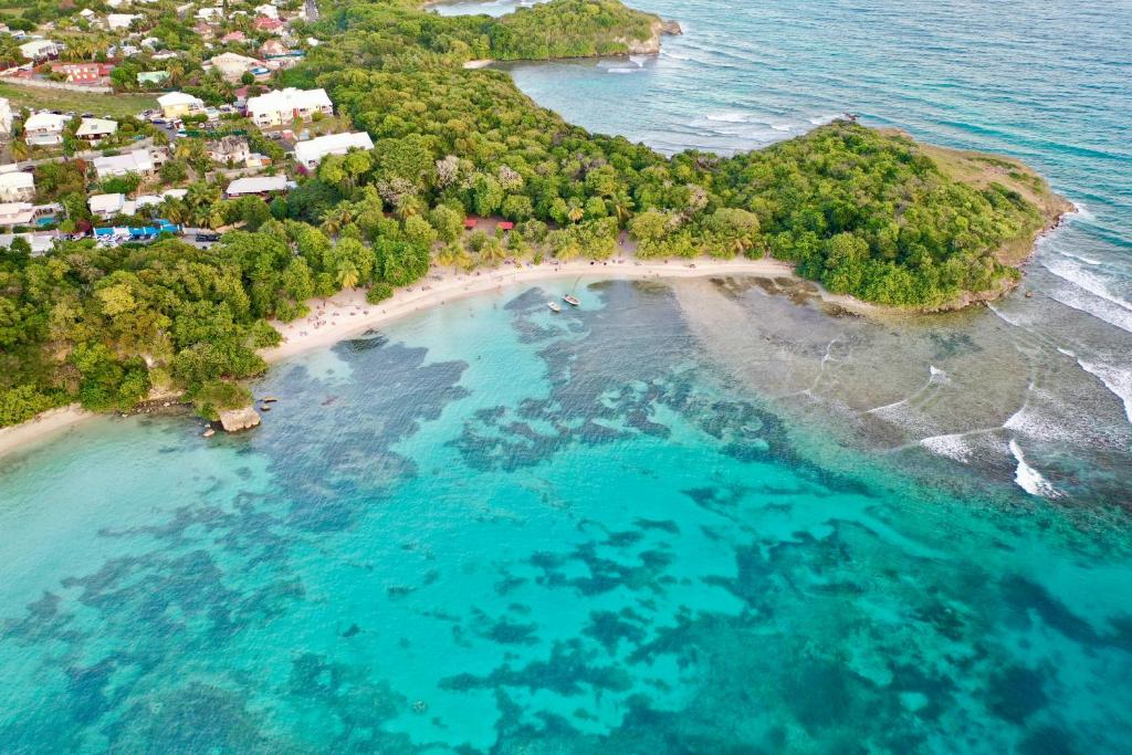 an aerial view of an island in the ocean at plage et spot de surf in Le Gosier