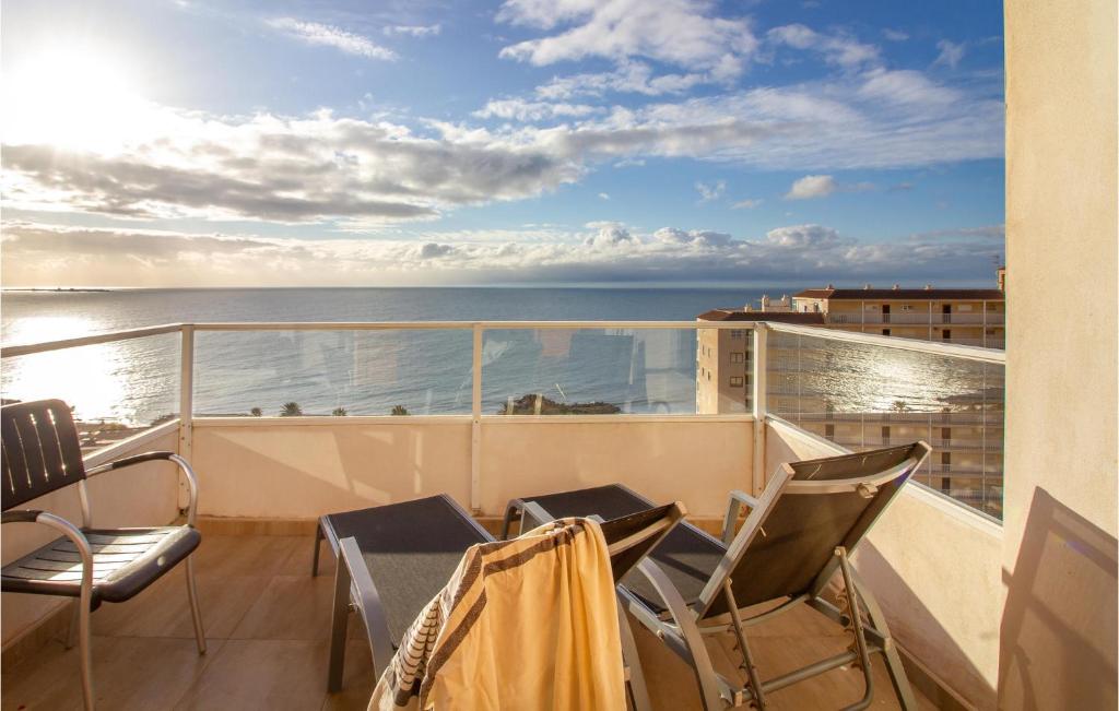 a balcony with chairs and a view of the ocean at 3 Bedroom Cozy Apartment In Santa Pola in Santa Pola