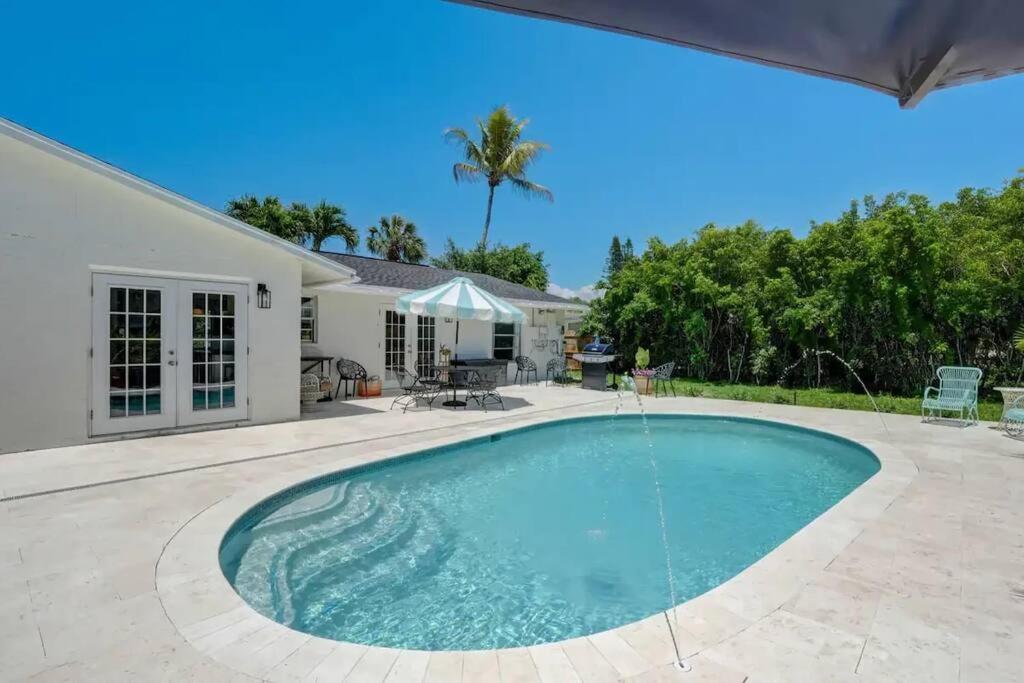 a swimming pool in the backyard of a house at Turtle Island - Family Friendly Pool Home -Welcome in Naples