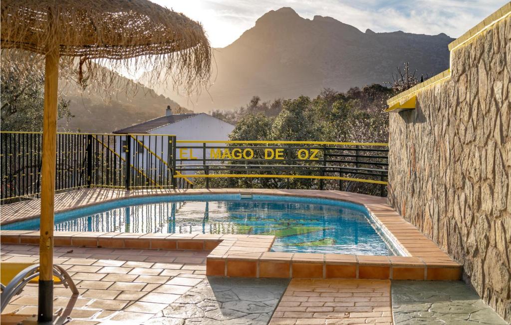 a swimming pool with a fence and a mountain at Awesome Home In Alfarnate With Kitchen in Alfarnatejo