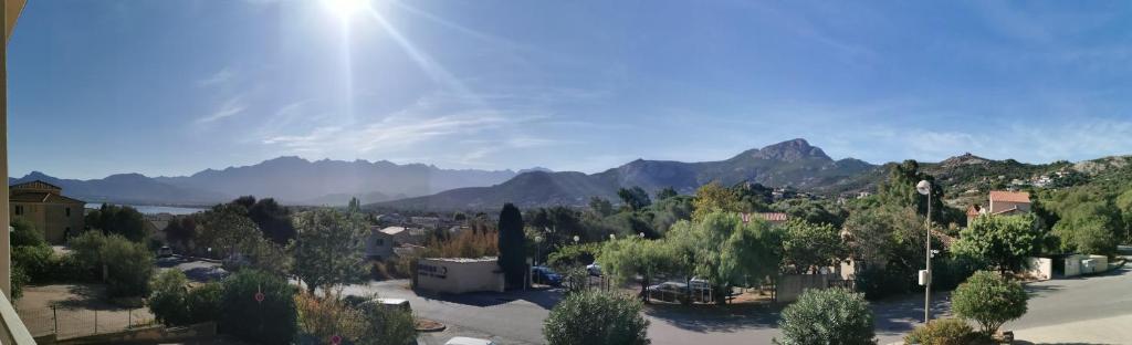 a view of a town with mountains in the background at Farfalla in Calvi