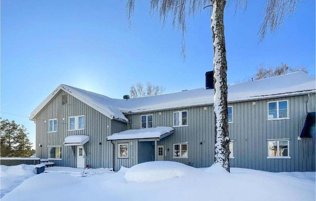 a gray barn with snow on the ground at Awesome Apartment In Mesnali With Internet in Mesnali