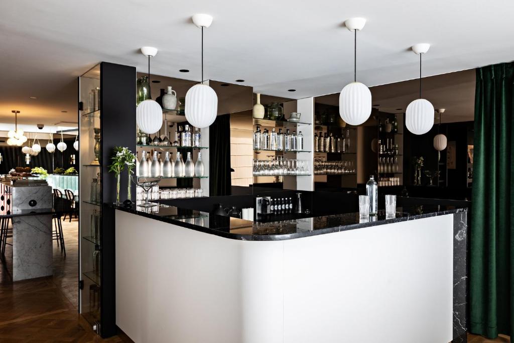 a bar in a restaurant with pendant lights at Holiday Inn Paris Elysées, an IHG Hotel in Paris