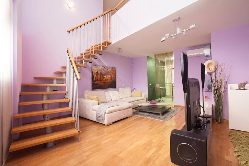 a living room with a staircase and a couch at Vale Beach in Barcelona