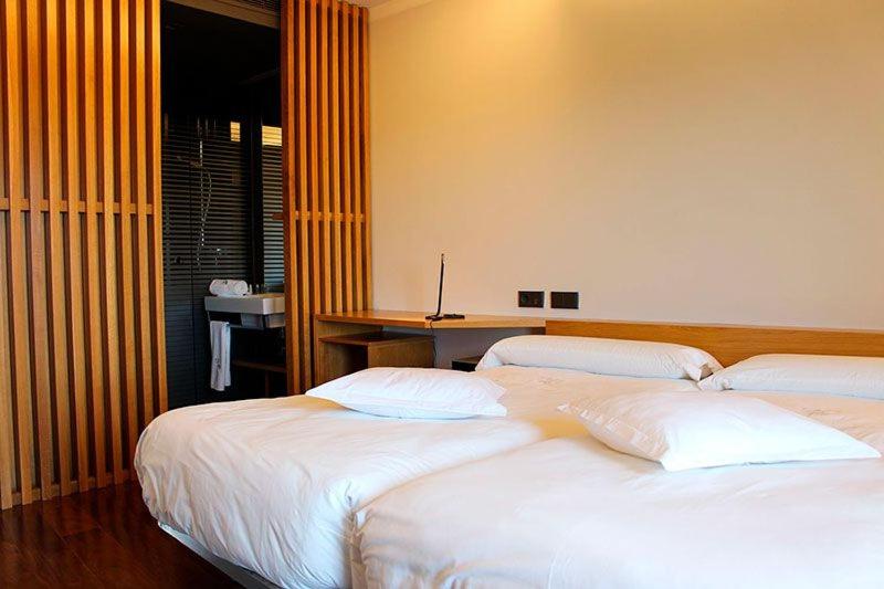 Postel nebo postele na pokoji v ubytování Hotel Raíz