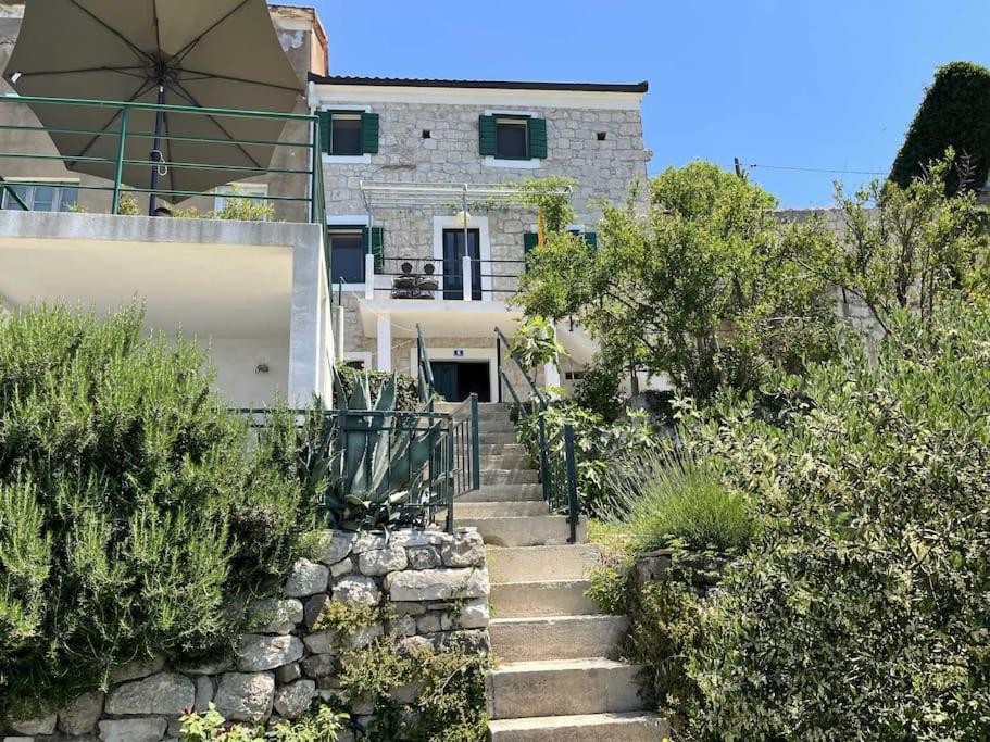 a set of stairs leading up to a house at Holiday Home Aria in Podgora