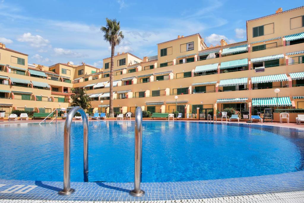 a swimming pool in front of a large building at Halcon - Costa del Silencio in Costa Del Silencio