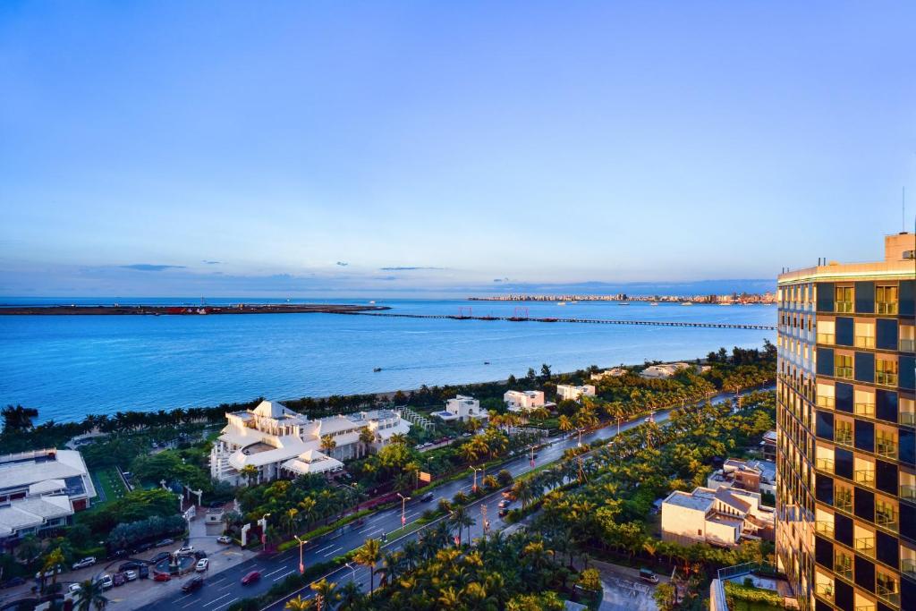 an aerial view of a city and the ocean at Holiday Inn Haikou West Coast, an IHG Hotel in Haikou