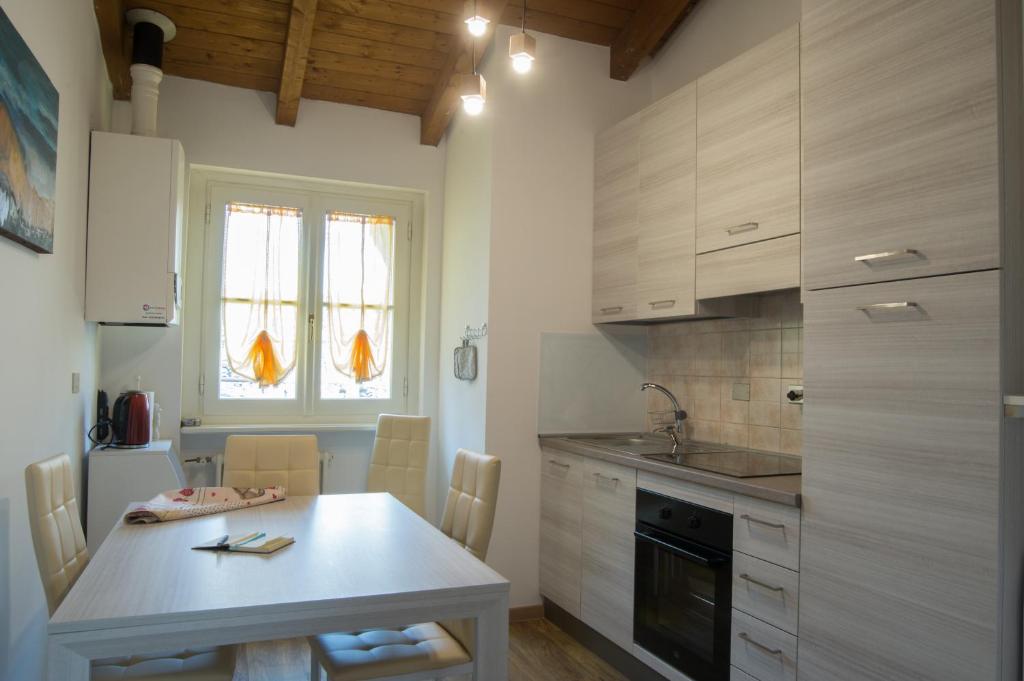 a kitchen with a table and a counter top at Il Borgo appartamento Luca in Parma