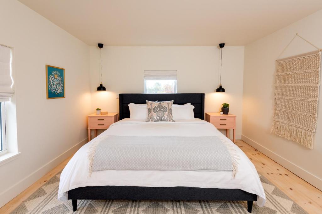 a bedroom with a large bed and two night stands at The August House in Windsor