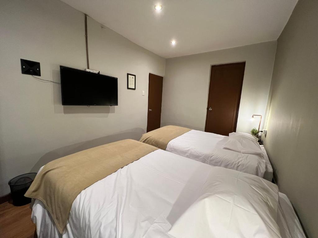 Postel nebo postele na pokoji v ubytování Hostal María Angola