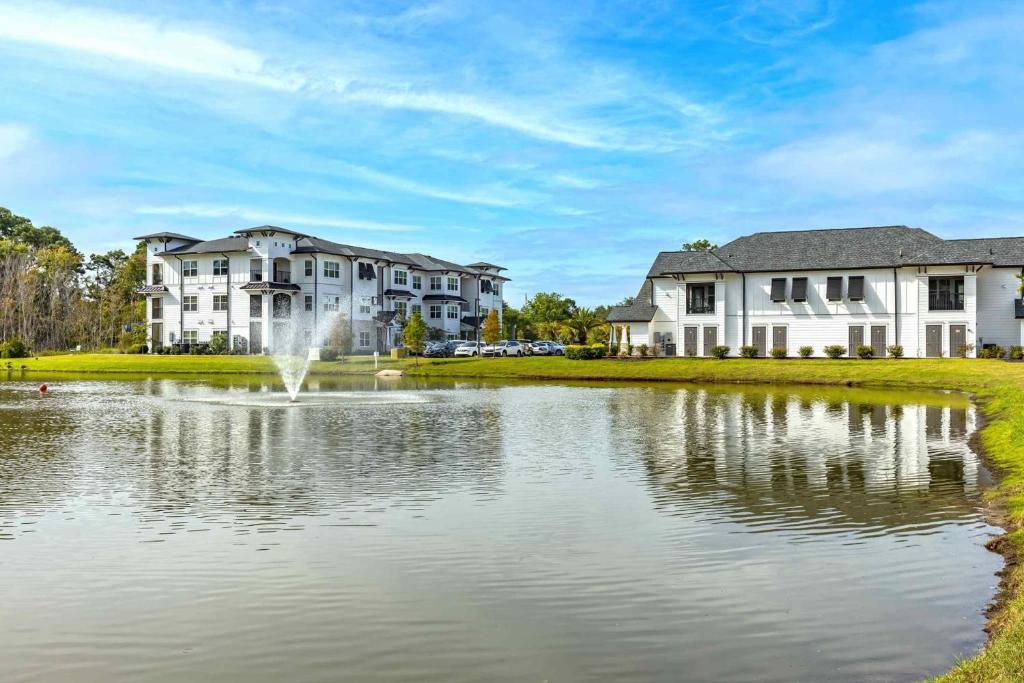 a pond with a fountain in front of houses at Chic 1 and 2 Bedroom Apartments at Vintage Amelia Island next to Fernandina Beach in Fernandina Beach