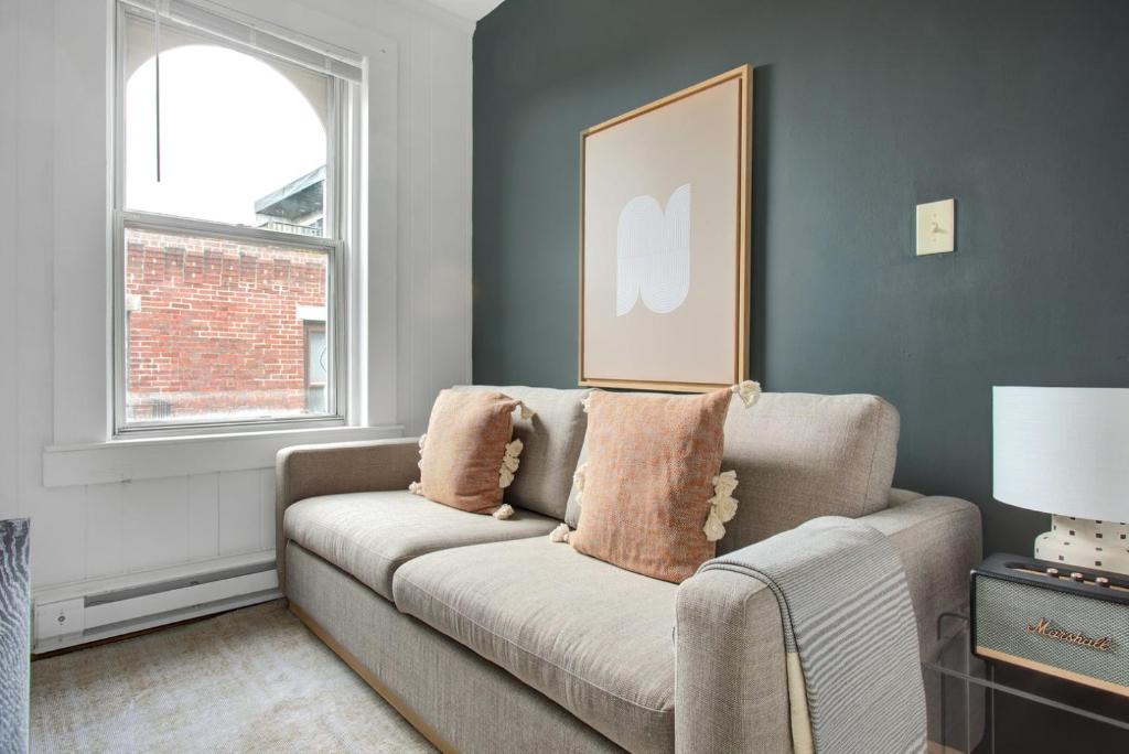 a living room with a couch and a window at Cozy N End 2BR steps from Harborwalk BOS-449 in Boston