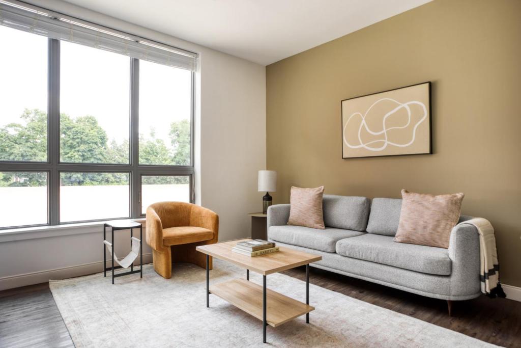 a living room with a couch and a table at Newton 1BR w WD nr Newtonville Train BOS-737 in Newton