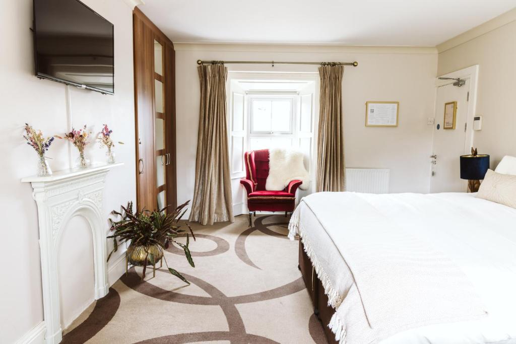 a bedroom with a bed and a fireplace at Fitz Of Inch - Self Catering in Stradbally