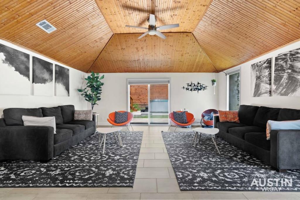 a living room with couches and a wooden ceiling at Vibrant, Quirky Home with Hot Tub Near S Congress in Austin