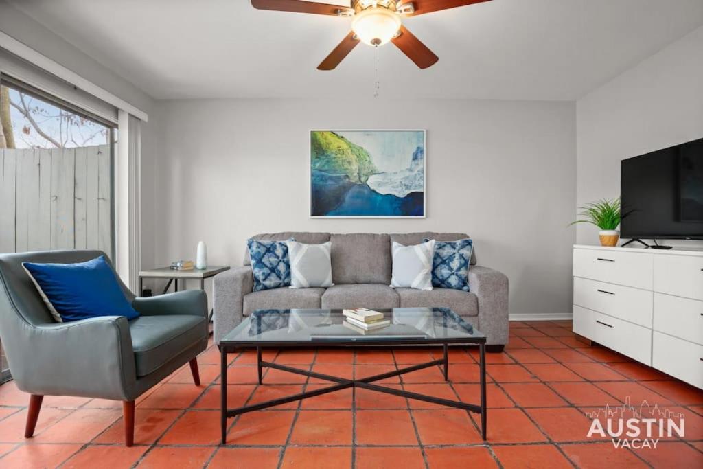 a living room with a couch and a ceiling fan at Enjoy Central Austin King Bed Smart TV and AC in Austin